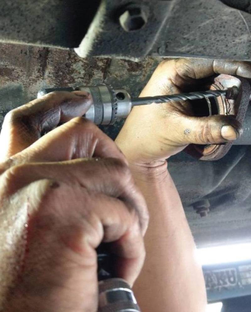 a man working on a car's brake assembly