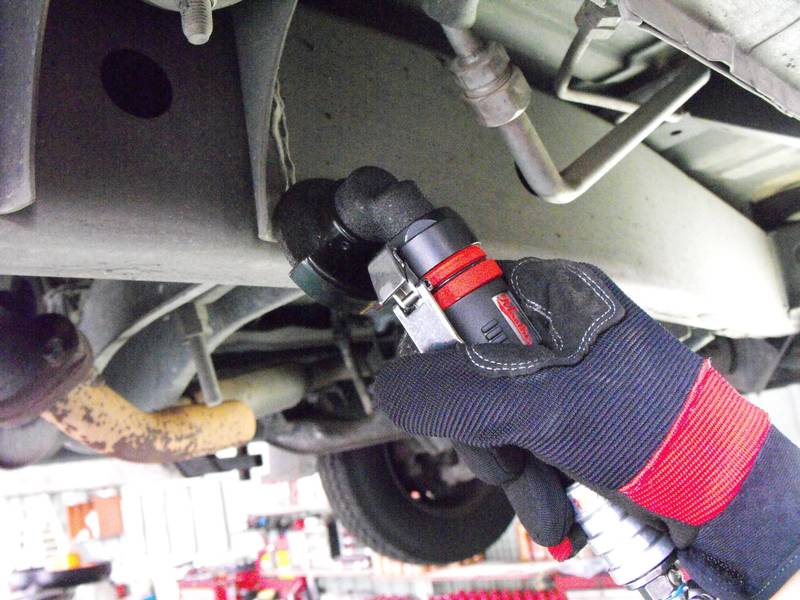 a man is working on a vehicle in a garage