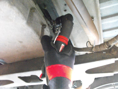 a man fixing a vehicle under a vehicle