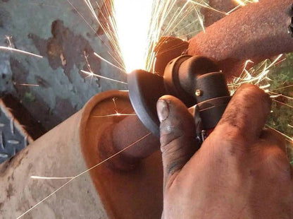 a man using a grinder on a piece of metal