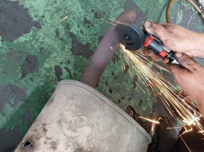 a person using a grinder on a piece of metal